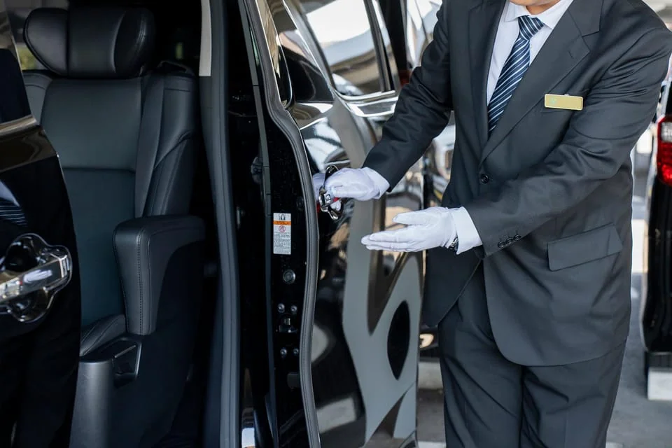 Haneda Airport private car meet and greet — licensed driver welcoming guests at arrivals hall